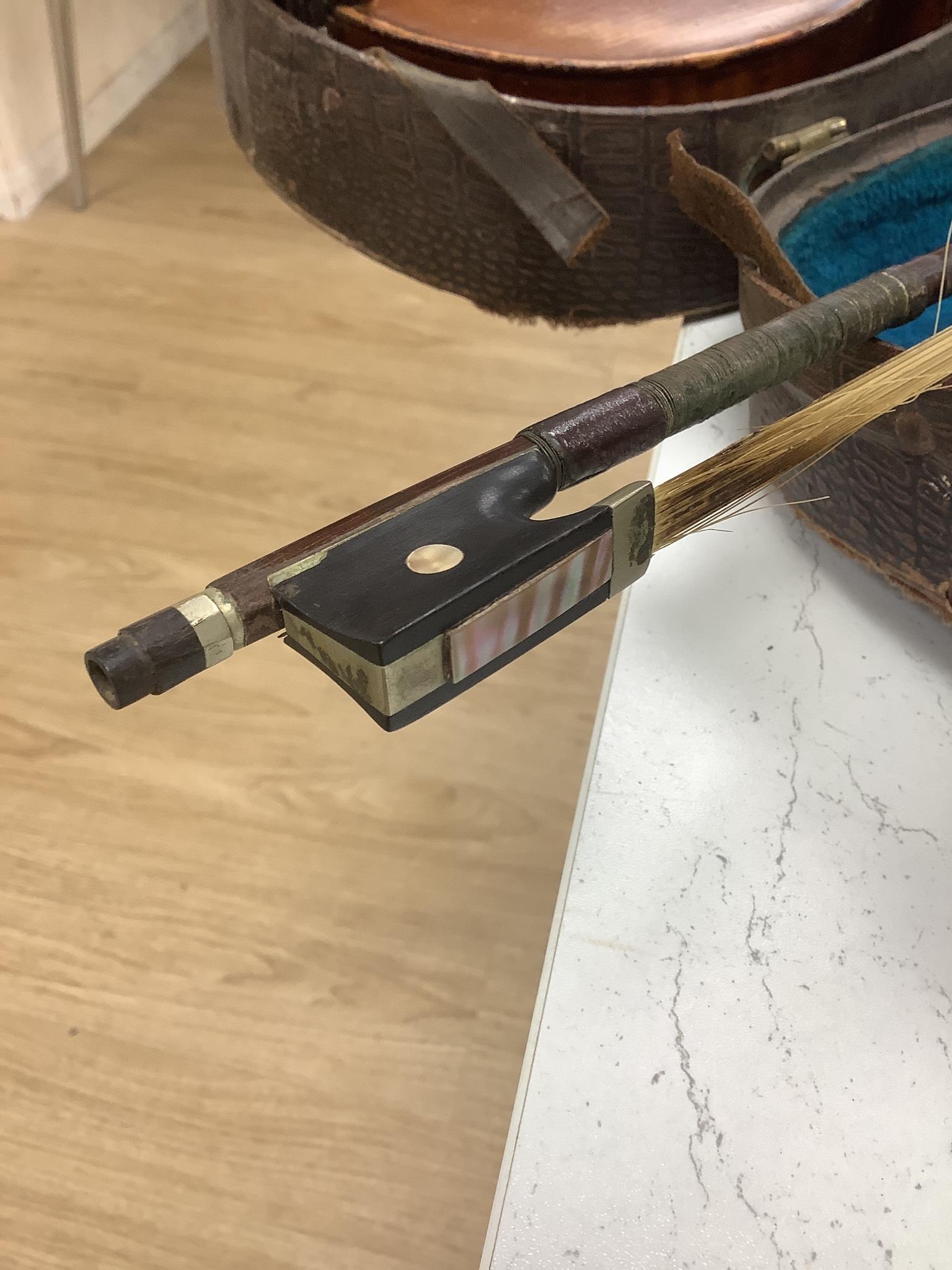 A cased violin, with bow